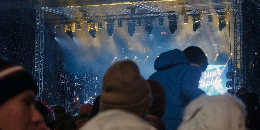 People at an outdoor concert in the snow
